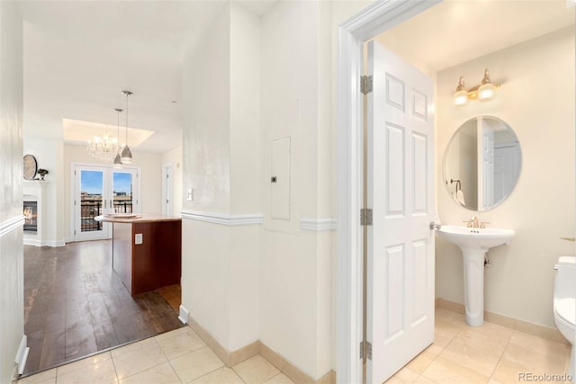 1827 N Grant St Unit 604, Denver, CO 80203 - hallway featuring electric panel, baseboards, a chandelier, and a sink