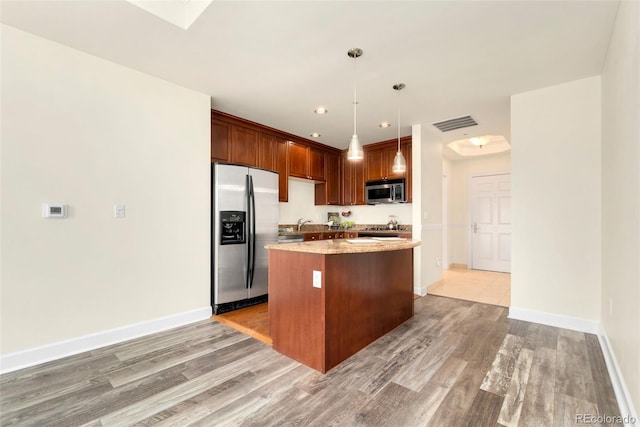 1827 N Grant St Unit 604, Denver, CO 80203 - kitchen featuring stainless steel appliances, light wood-type flooring, a center island, baseboards, and recessed lighting