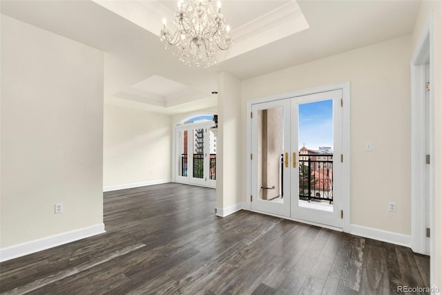 1827 N Grant St Unit 604, Denver, CO 80203 - spare room featuring a tray ceiling, french doors, dark wood-style flooring, a chandelier, and baseboards