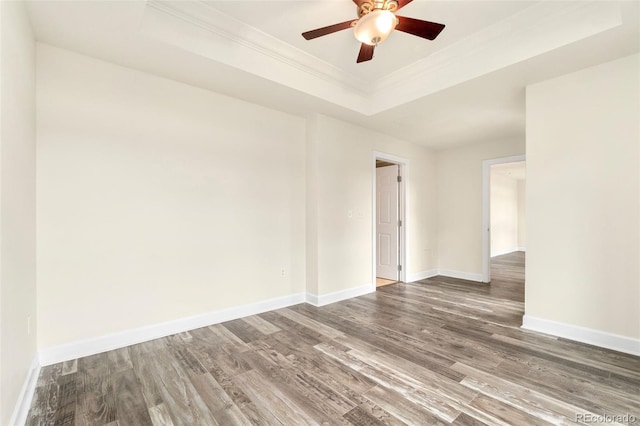 1827 N Grant St Unit 604, Denver, CO 80203 - spare room featuring wood finished floors, a ceiling fan, crown molding, a tray ceiling, and baseboards