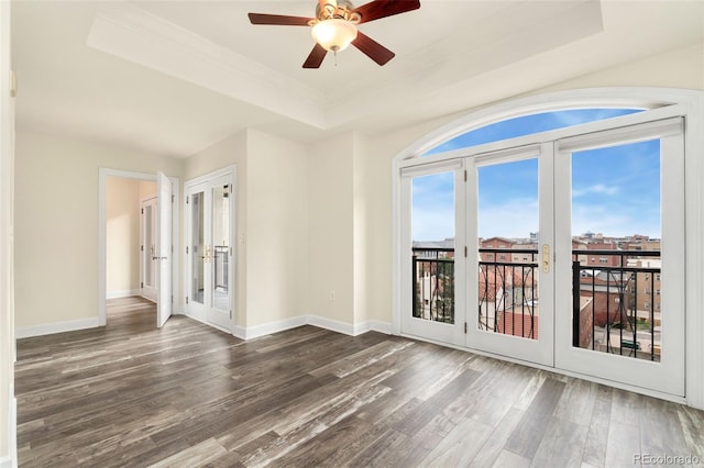 1827 N Grant St Unit 604, Denver, CO 80203 - spare room featuring a raised ceiling, french doors, wood finished floors, ceiling fan, and baseboards