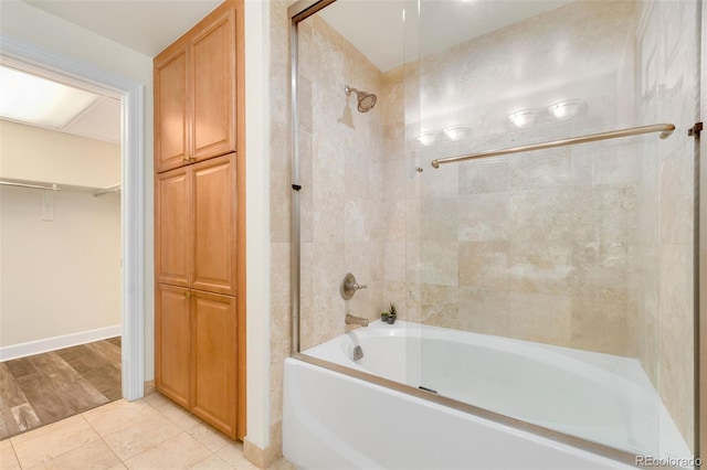 1827 N Grant St Unit 604, Denver, CO 80203 - bathroom featuring shower / tub combination, tile patterned flooring, a walk in closet, and baseboards