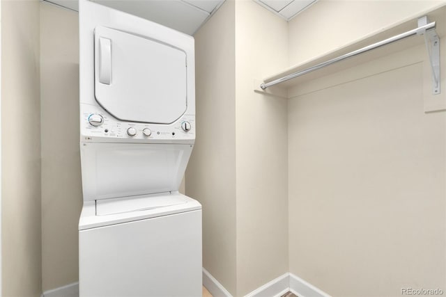 1827 N Grant St Unit 604, Denver, CO 80203 - washroom with stacked washing machine and dryer and baseboards