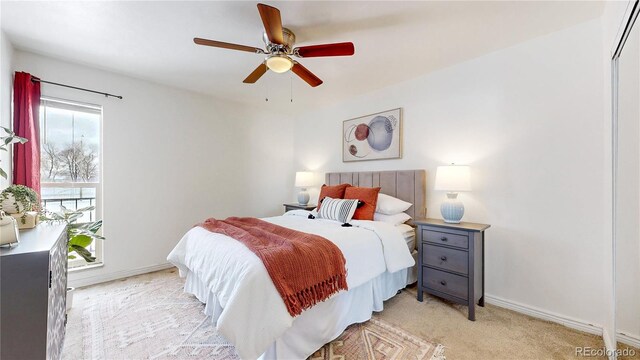 bedroom with light carpet, ceiling fan, and baseboards