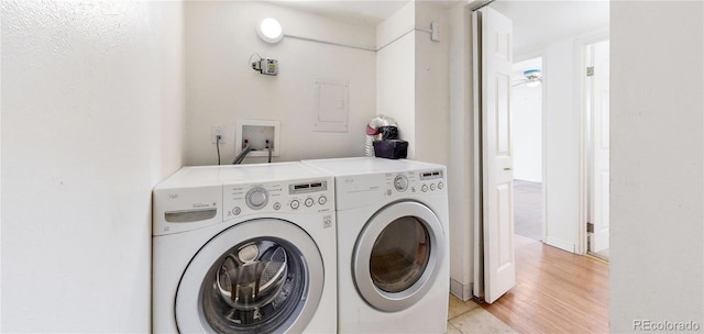 laundry room with light wood-style floors, laundry area, and independent washer and dryer