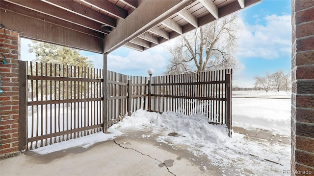 snow covered gate featuring fence