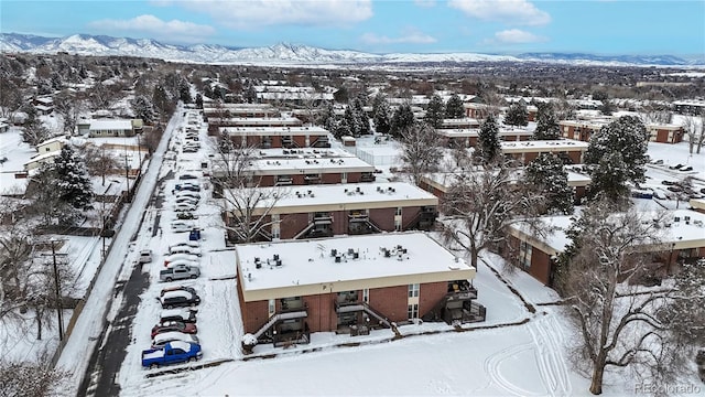 snowy aerial view featuring a mountain view