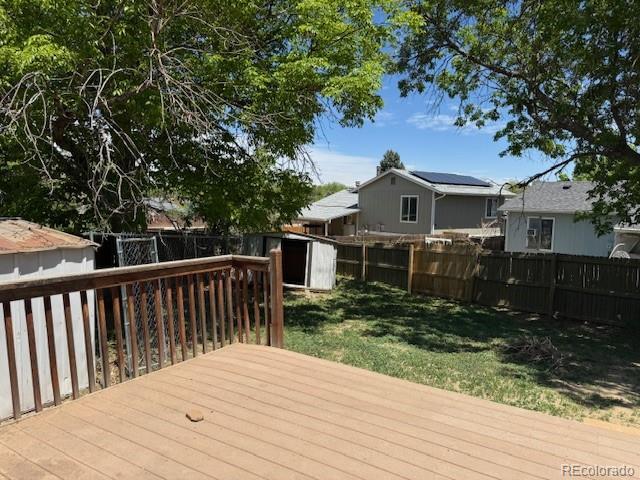 16753 E Ithaca Pl, Aurora, CO 80013 - wooden terrace featuring a fenced backyard and a shed