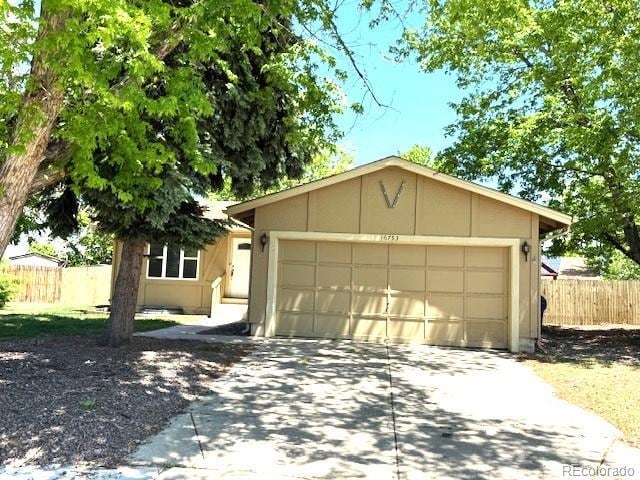 16753 E Ithaca Pl, Aurora, CO 80013 - single story home with driveway, an attached garage, and stucco siding