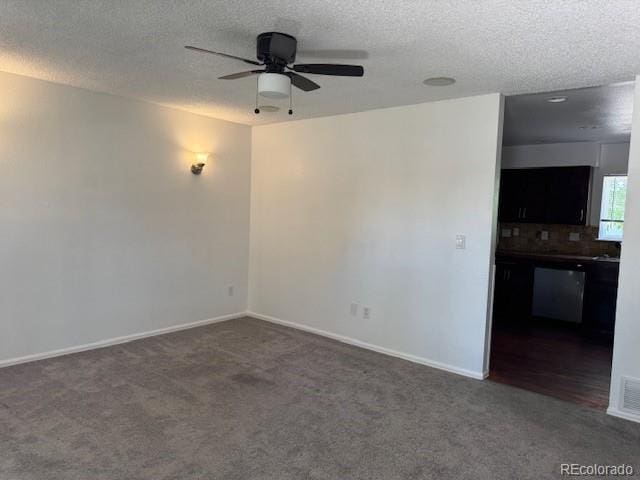 16753 E Ithaca Pl, Aurora, CO 80013 - unfurnished room with dark colored carpet, a ceiling fan, and a textured ceiling