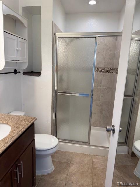16753 E Ithaca Pl, Aurora, CO 80013 - bathroom with vanity, a stall shower, and tile patterned flooring