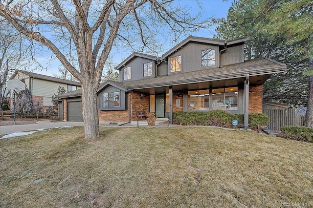 view of front facade with brick siding, an attached garage, a front yard, fence, and driveway