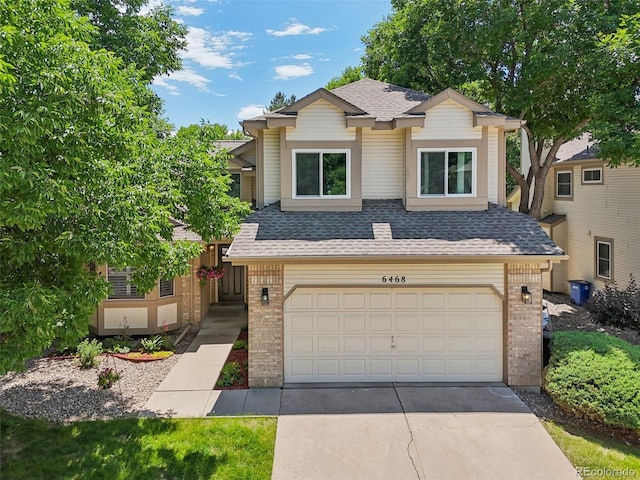 6468 S Forest St, Centennial, CO 80121 - view of front of property with brick siding, roof with shingles, an attached garage, and concrete driveway