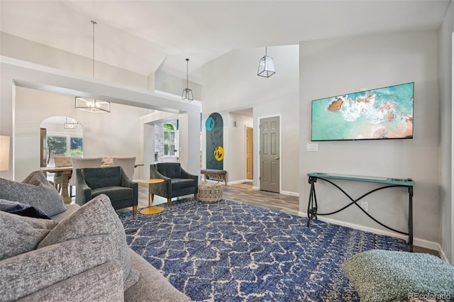 6468 S Forest St, Centennial, CO 80121 - living room with healthy amount of natural light, wood finished floors, arched walkways, and high vaulted ceiling