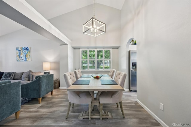 6468 S Forest St, Centennial, CO 80121 - dining area featuring vaulted ceiling, a chandelier, wood finished floors, and arched walkways