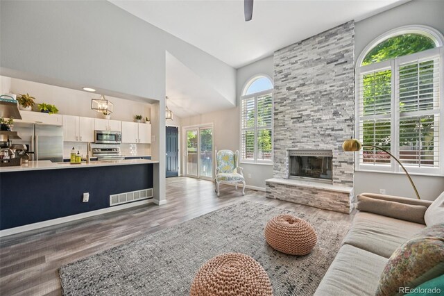 6468 S Forest St, Centennial, CO 80121 - living area featuring wood finished floors, a high ceiling, a fireplace, and ceiling fan