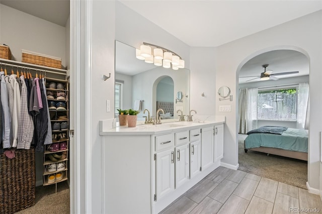 6468 S Forest St, Centennial, CO 80121 - ensuite bathroom with double vanity, ceiling fan, a spacious closet, and wood finish floors
