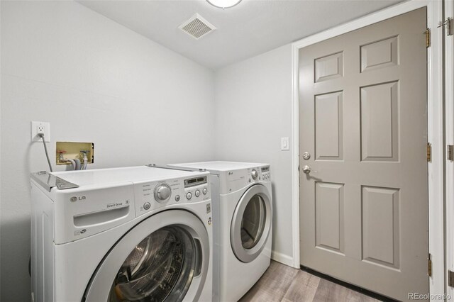 6468 S Forest St, Centennial, CO 80121 - laundry area featuring separate washer and dryer and light wood-style flooring