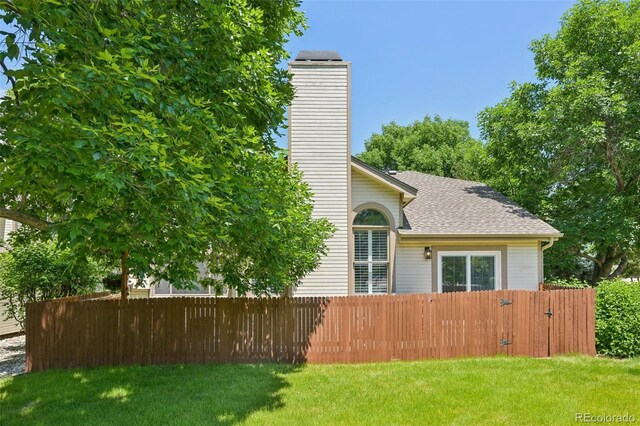 6468 S Forest St, Centennial, CO 80121 - view of home's exterior with a chimney and roof with shingles