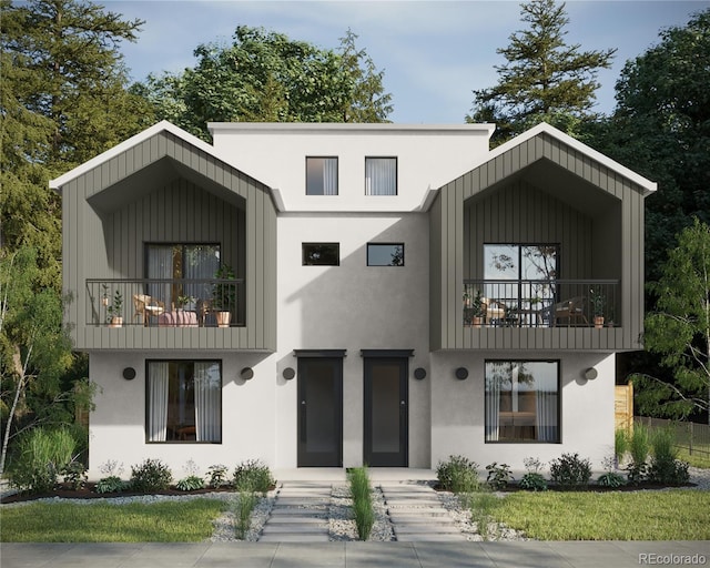 view of front of property featuring elevator, stucco siding, and a balcony