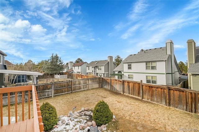 view of yard featuring a fenced backyard and a residential view