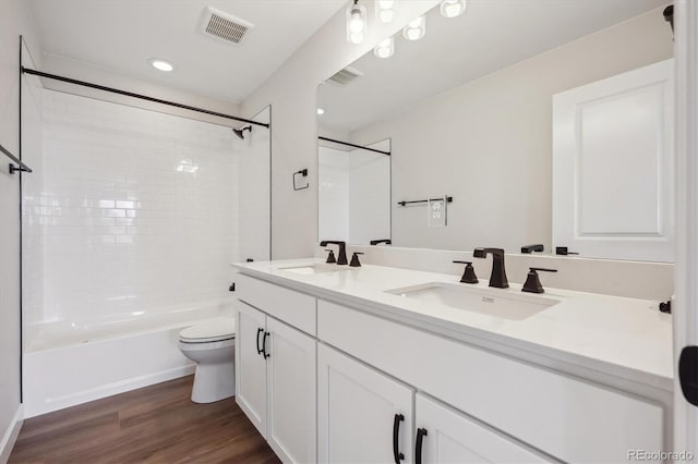 bathroom with visible vents, wood finished floors, and a sink