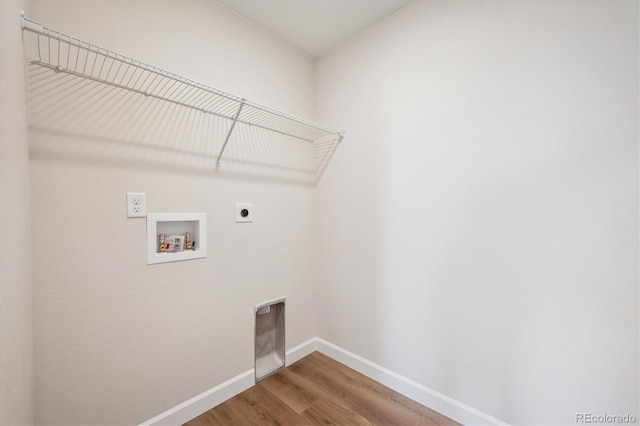 laundry room featuring baseboards, hookup for a washing machine, wood finished floors, laundry area, and electric dryer hookup