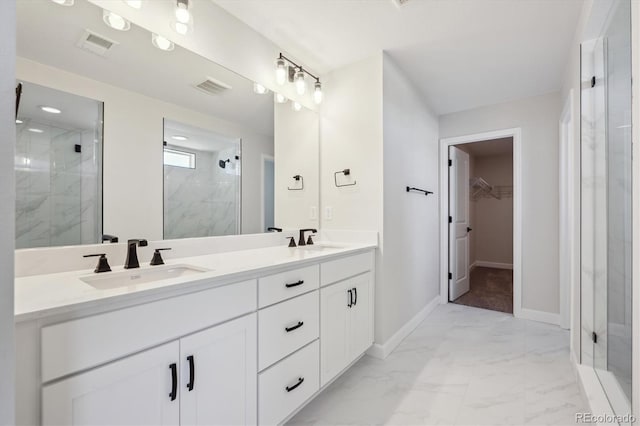 full bathroom with a marble finish shower, marble finish floor, visible vents, and a sink