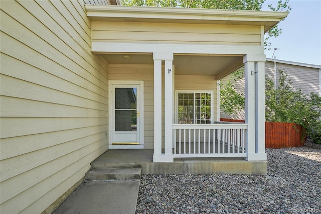 1481 Box Prairie Cir, Loveland, CO 80538 - view of exterior entry featuring covered porch and fence