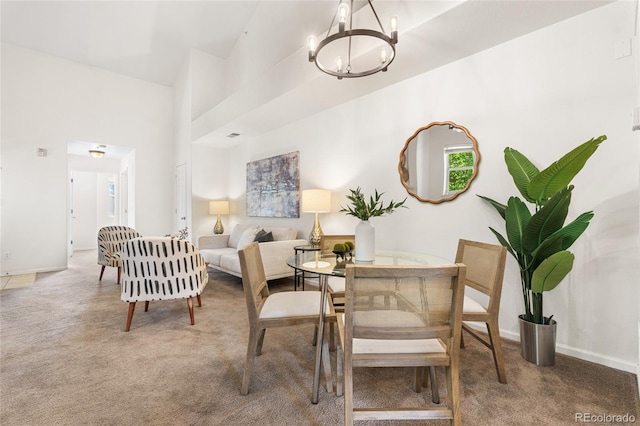 5444 Zephyr St Unit 203, Arvada, CO 80002 - carpeted dining room featuring a chandelier and baseboards