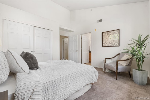5444 Zephyr St Unit 203, Arvada, CO 80002 - bedroom with light carpet, a closet, baseboards, and a high ceiling