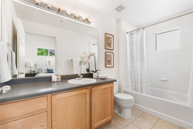 5444 Zephyr St Unit 203, Arvada, CO 80002 - full bathroom with tile patterned flooring, vanity, toilet, shower / bath combo, and ensuite bath