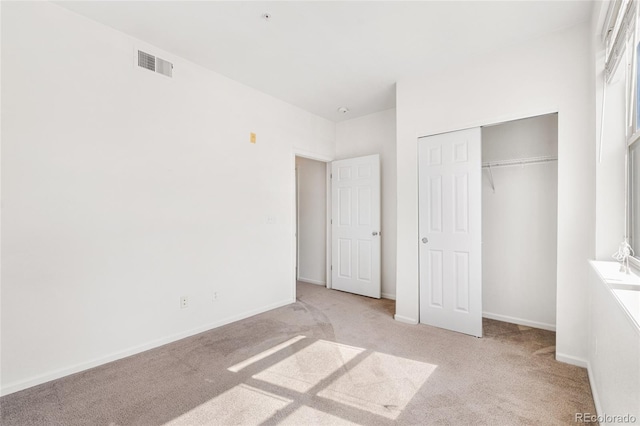 5444 Zephyr St Unit 203, Arvada, CO 80002 - unfurnished bedroom with light carpet, a closet, and baseboards