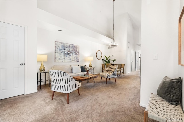 5444 Zephyr St Unit 203, Arvada, CO 80002 - living room featuring carpet floors, a towering ceiling, and baseboards