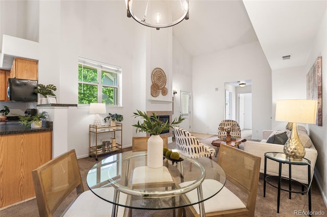 5444 Zephyr St Unit 203, Arvada, CO 80002 - dining area with a high ceiling, baseboards, and a chandelier