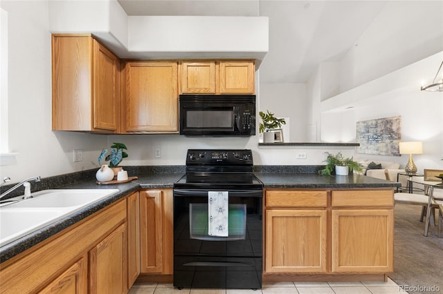 5444 Zephyr St Unit 203, Arvada, CO 80002 - kitchen with black appliances, dark countertops, a peninsula, a sink, and light tile patterned flooring