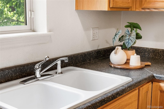 5444 Zephyr St Unit 203, Arvada, CO 80002 - kitchen view of a sink, dark countertops, and brown cabinets