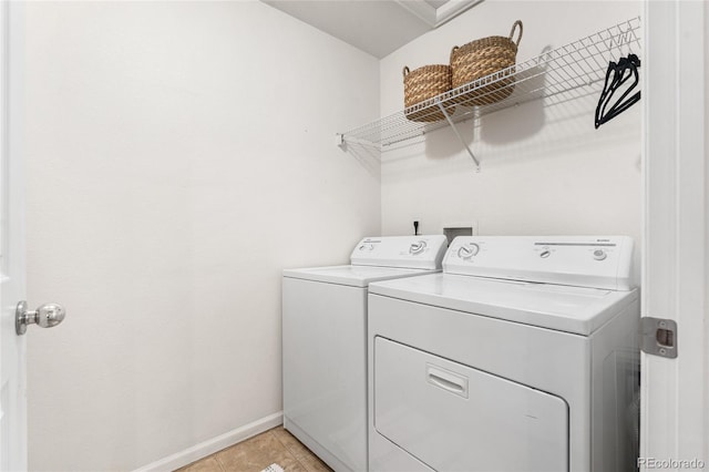 5444 Zephyr St Unit 203, Arvada, CO 80002 - washroom with washer and clothes dryer, baseboards, and light tile patterned flooring