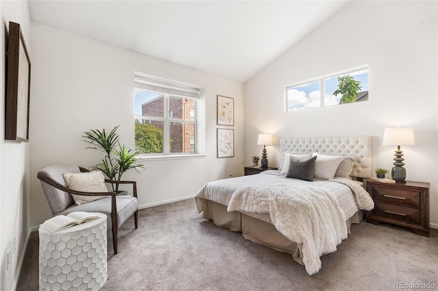 5444 Zephyr St Unit 203, Arvada, CO 80002 - bedroom with light carpet, multiple windows, baseboards, and lofted ceiling