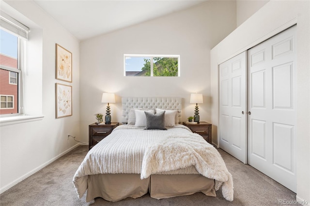 5444 Zephyr St Unit 203, Arvada, CO 80002 - bedroom featuring carpet floors, multiple windows, vaulted ceiling, and a closet
