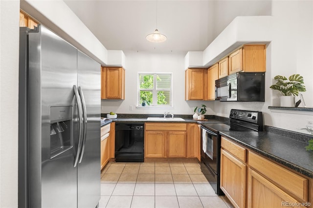 5444 Zephyr St Unit 203, Arvada, CO 80002 - kitchen with black appliances, a sink, light tile patterned floors, dark countertops, and hanging light fixtures