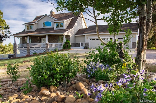 34274 Wolf Creek Trl, Kiowa, CO 80117 - craftsman-style house featuring a chimney, a garage, covered porch, and stone siding