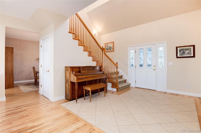 34274 Wolf Creek Trl, Kiowa, CO 80117 - foyer featuring stairs, light wood-style floors, baseboards, and a towering ceiling