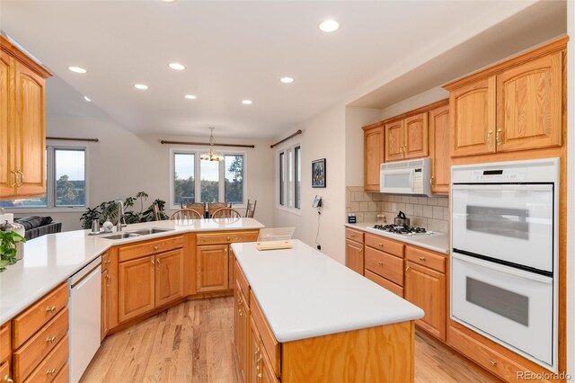 34274 Wolf Creek Trl, Kiowa, CO 80117 - kitchen featuring white appliances, a sink, light wood-type flooring, recessed lighting, and light countertops