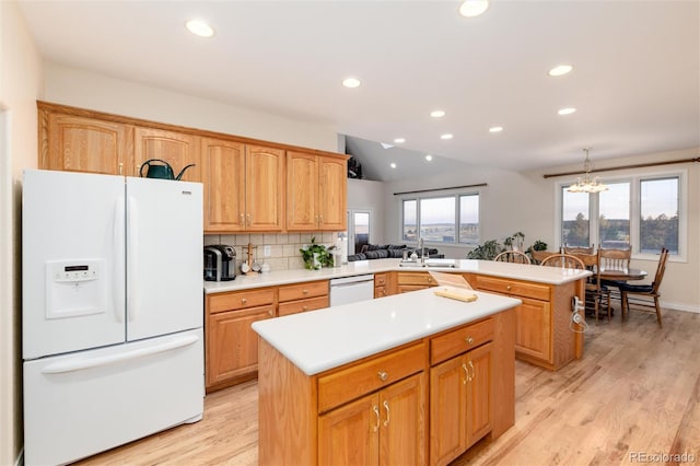 34274 Wolf Creek Trl, Kiowa, CO 80117 - kitchen with white appliances, a sink, a peninsula, a kitchen island, and light wood-style flooring