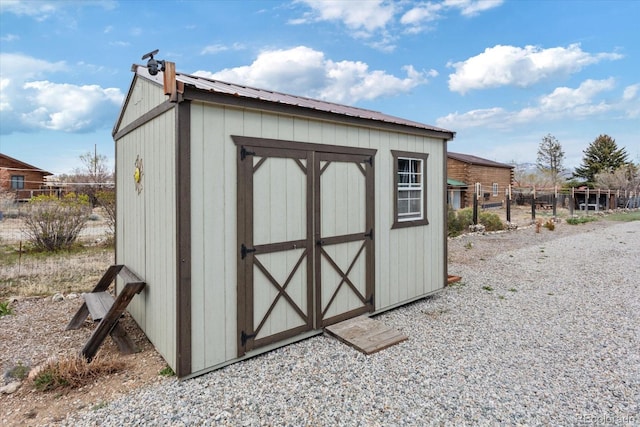 view of shed featuring fence