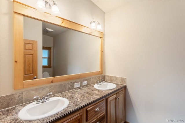 full bath with a sink and double vanity