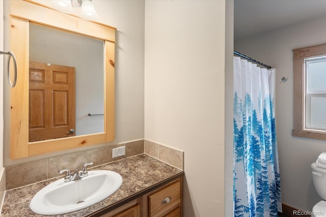 bathroom with vanity, a shower with shower curtain, and toilet