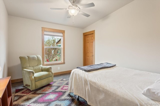 bedroom featuring baseboards, ceiling fan, wood finished floors, and lofted ceiling
