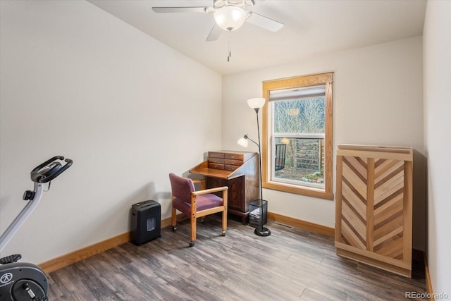 misc room with baseboards, ceiling fan, and wood finished floors